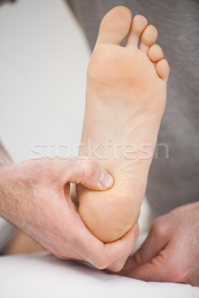 Foot being raised by a chiropodist in a room Stock photo © wavebreak_media