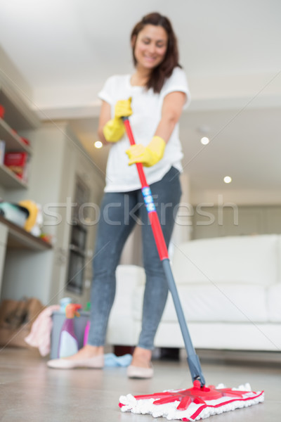 Brunette mopping the floor of living room Stock photo © wavebreak_media
