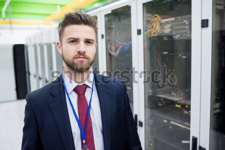 Man looking up thoughtfully into server locker Stock photo © wavebreak_media