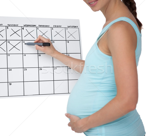 Pregnant woman marking off dates on the calendar  Stock photo © wavebreak_media