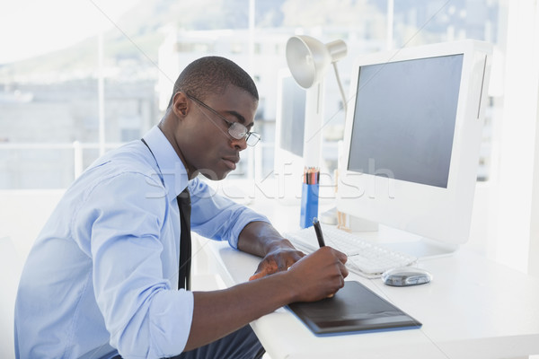 Stock photo: Focused businessman working at his desk