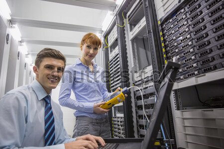 Team of technicians using digital cable analyser on servers Stock photo © wavebreak_media