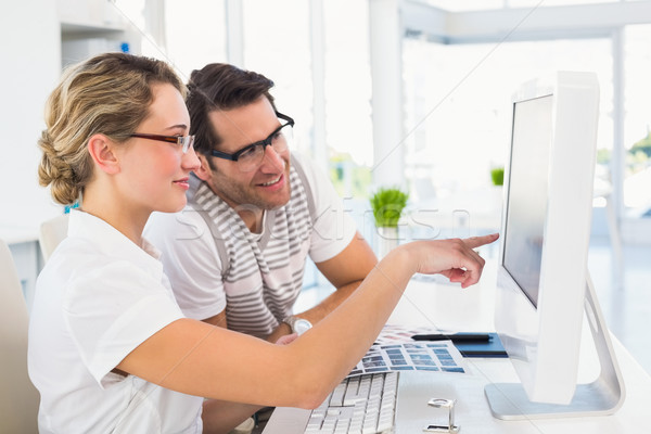 Stock photo: Smiling photo editors using computer