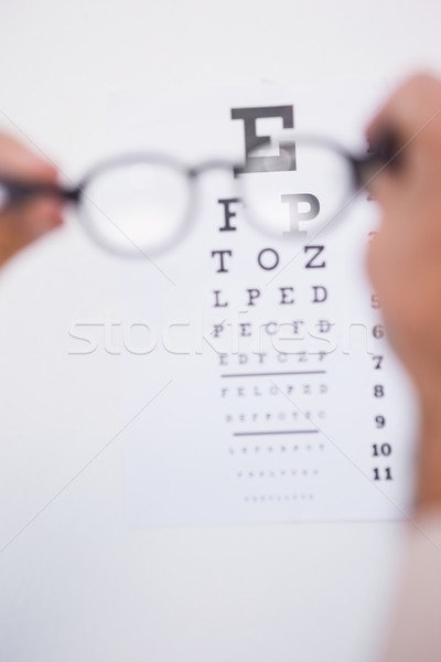 Reading glasses looking at eye test Stock photo © wavebreak_media