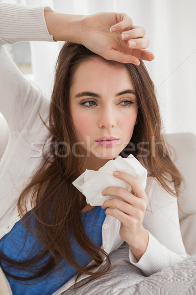 Sick brunette on the couch Stock photo © wavebreak_media
