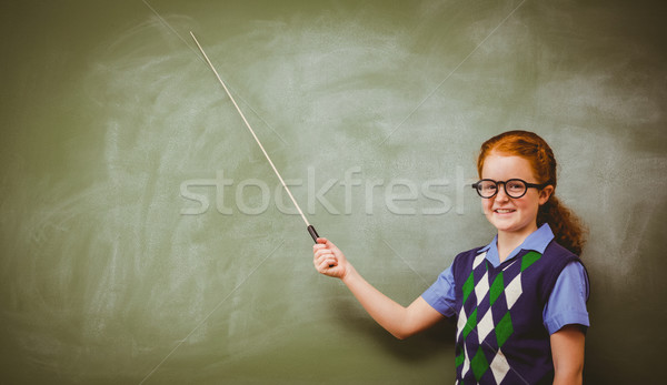 Little girl holding stick in front of blackboard Stock photo © wavebreak_media