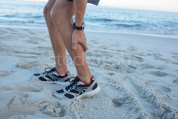 Fitt férfi izomfájdalom tengerpart tavasz tenger Stock fotó © wavebreak_media