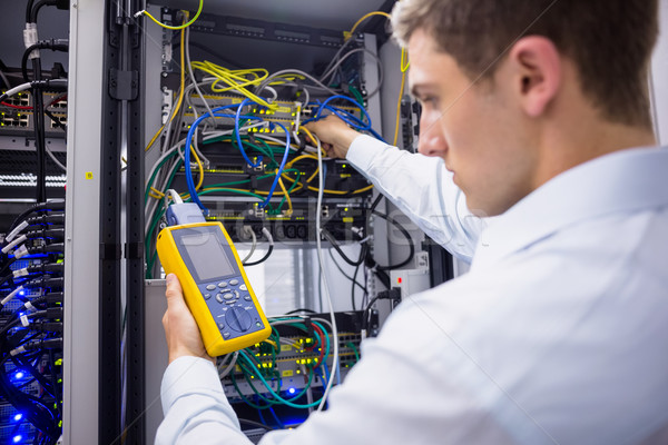 Serious technician using digital cable analyzer on server Stock photo © wavebreak_media