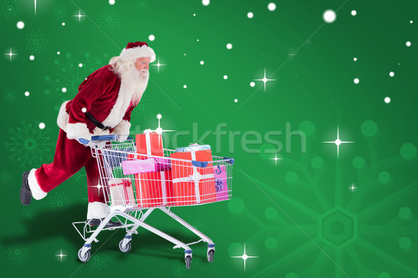 Composite image of santa pushes a shopping cart Stock photo © wavebreak_media