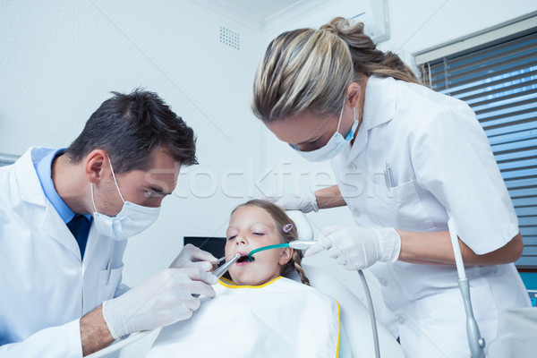Male dentist  with assistant examining girls teeth Stock photo © wavebreak_media