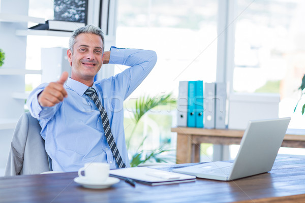 Happy businessman looking at camera with thumbs up  Stock photo © wavebreak_media