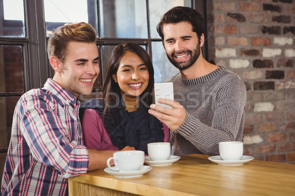 Group of friends taking selfies with a smartphone Stock photo © wavebreak_media