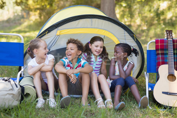 Happy friends sitting in tent Stock photo © wavebreak_media
