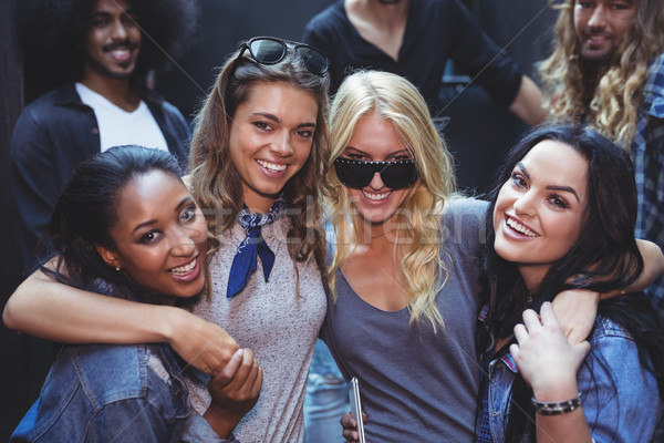 Portrait of happy women with male friends in background Stock photo © wavebreak_media