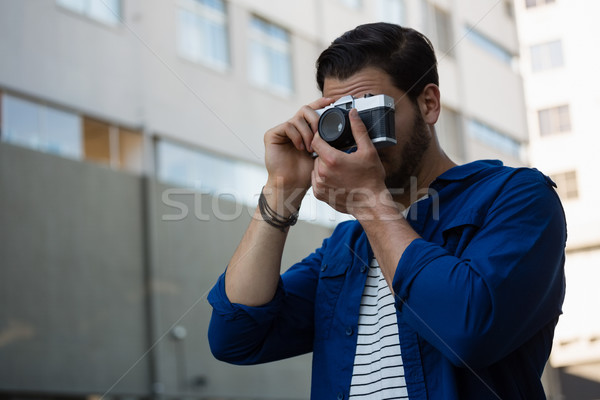 Young man photographing through camera Stock photo © wavebreak_media