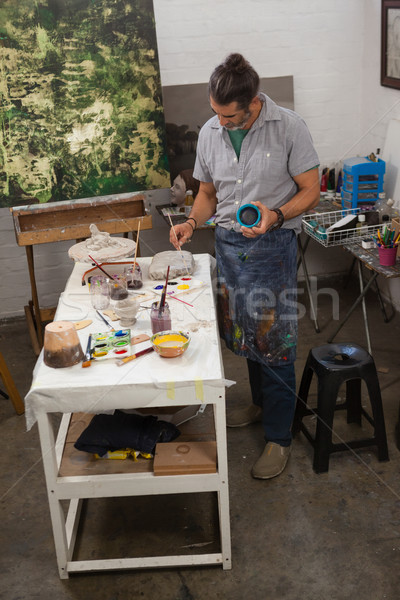 Attentive man painting bowl Stock photo © wavebreak_media