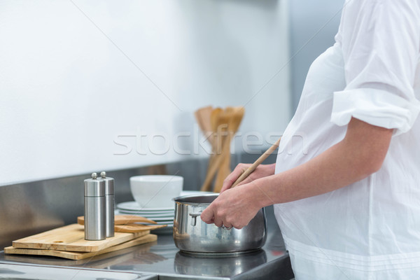 Pregnant woman busy in kitchen Stock photo © wavebreak_media