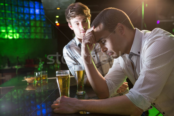 Homem reconfortante deprimido amigo bar festa Foto stock © wavebreak_media