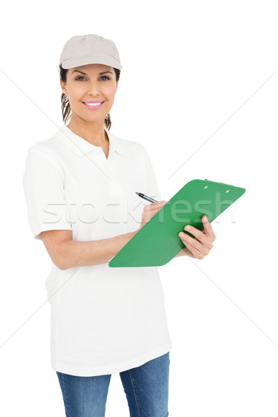 Delivery woman signing a clipboard Stock photo © wavebreak_media