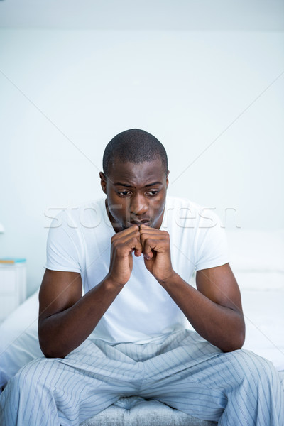 Tensed young man sitting on bed Stock photo © wavebreak_media
