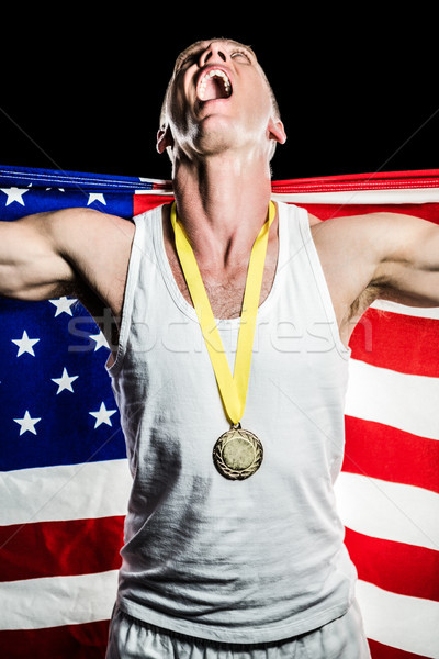 Athlète posant médaille d'or victoire drapeau américain noir [[stock_photo]] © wavebreak_media