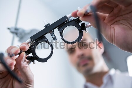 Female optometrist looking at messbrille Stock photo © wavebreak_media