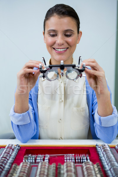 Optician looking at trial frame Stock photo © wavebreak_media