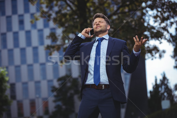 Handsome businessman talking on mobile phone Stock photo © wavebreak_media