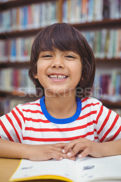 Pupil reading book at desk in library Stock photo © wavebreak_media