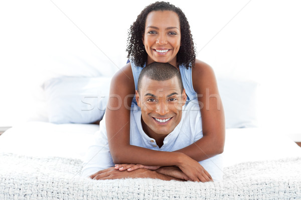 Portrait of  an intimate couple cuddling lying down on bed Stock photo © wavebreak_media