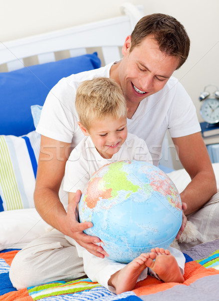 Merry father and his son looking at a terrestrial globe Stock photo © wavebreak_media