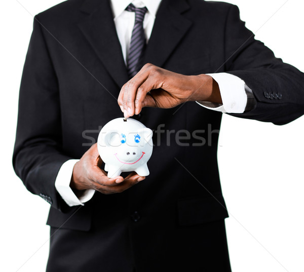 Close-up of a Businessman putting money in his piggy bank  Stock photo © wavebreak_media