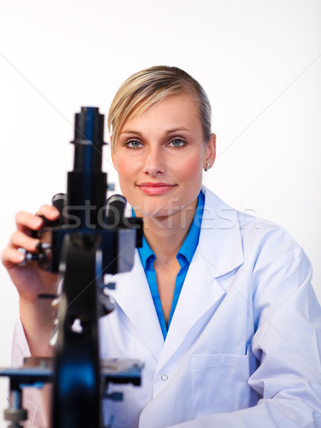 Belle scientifique travail microscope regarder caméra [[stock_photo]] © wavebreak_media