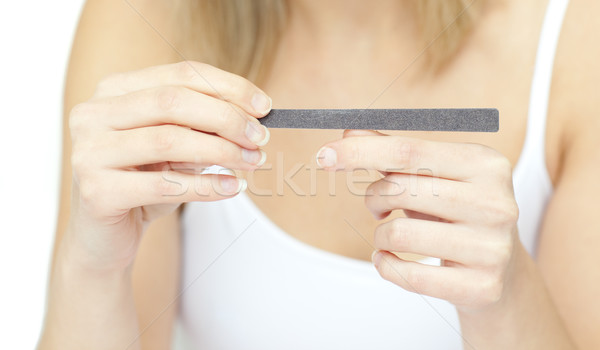 Portrait of a beautiful woman filing her nails Stock photo © wavebreak_media