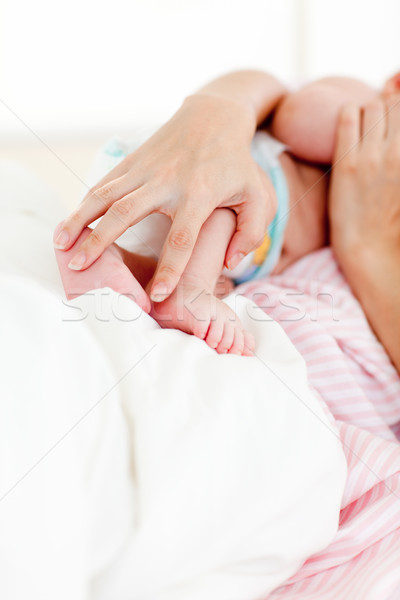 Hands holding a newborn baby in bed Stock photo © wavebreak_media