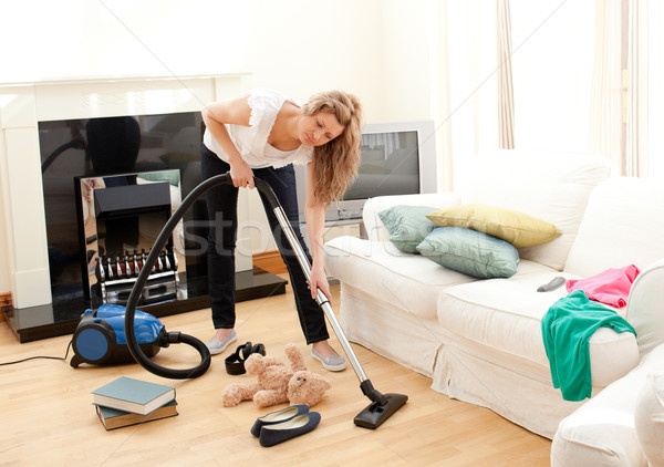 Portrait of a bored woman vacuuming at home  Stock photo © wavebreak_media