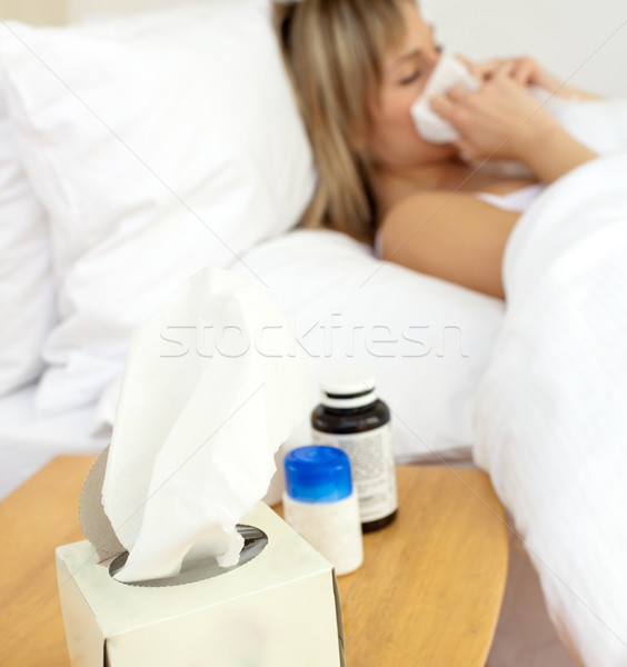 Sick young woman lying in bed Stock photo © wavebreak_media