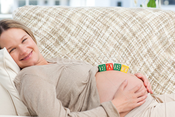 Pretty future mom with baby letters on the belly Stock photo © wavebreak_media