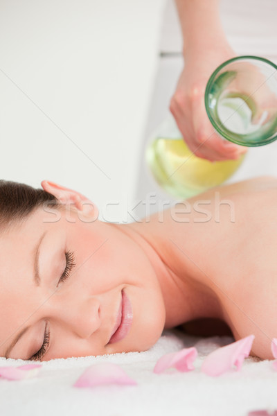 Portrait of a young female having massage oil versed on her back Stock photo © wavebreak_media