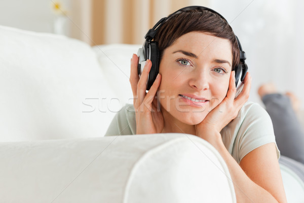 Close up of a short-haired brunette listening to music looking at the camera Stock photo © wavebreak_media