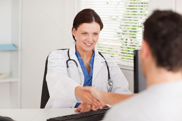 Stock photo: A female doctor is greeting a patient in her office