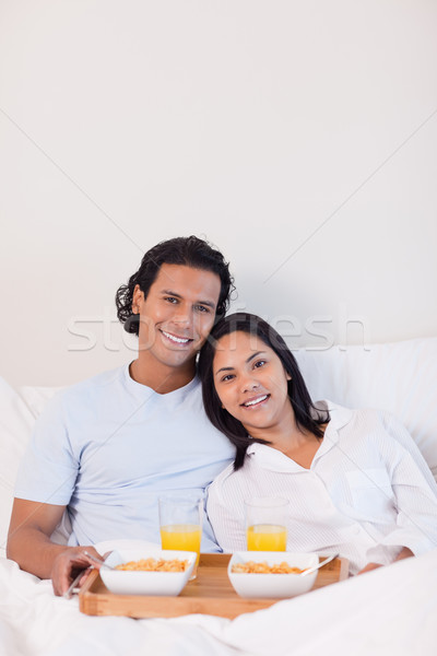 Happy young couple having breakfast in the bed Stock photo © wavebreak_media