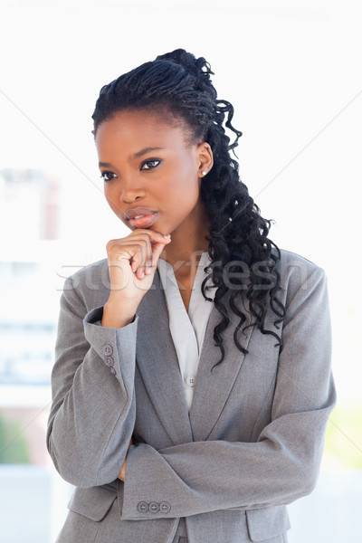 Executive woman looking towards the side with her hand on her chin in a well-lit room Stock photo © wavebreak_media