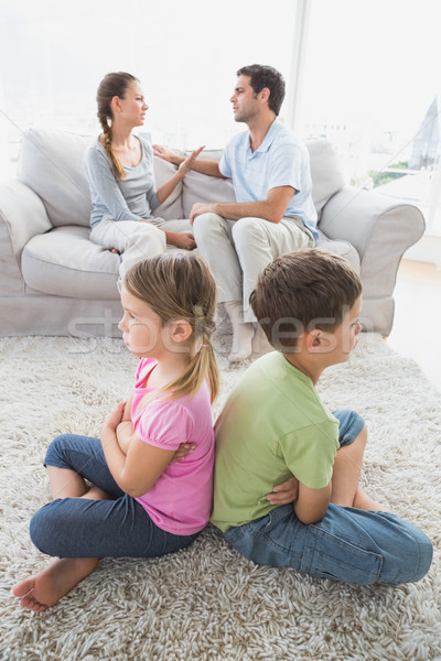 Siblings sitting back-to-back while parents are arguing Stock photo © wavebreak_media
