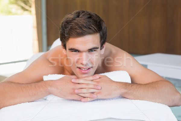 Man lying on massage table at spa center Stock photo © wavebreak_media