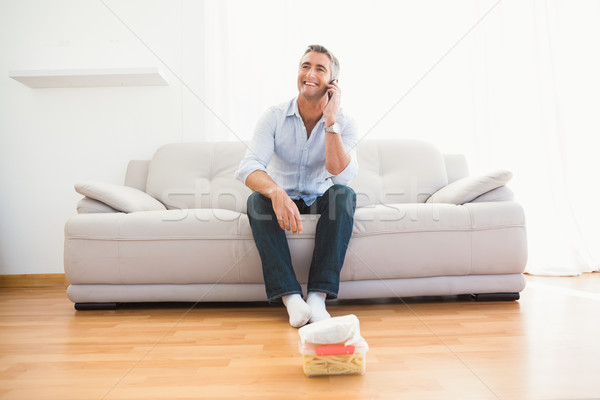 Smiling man phoning on the couch Stock photo © wavebreak_media