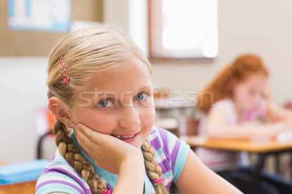 Smiling pupil sitting at her desk  Stock photo © wavebreak_media