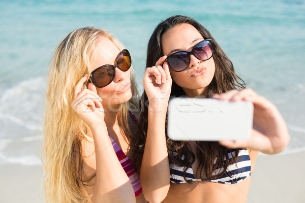 two friends in swimsuits taking a selfie Stock photo © wavebreak_media