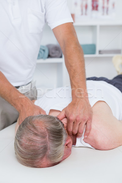 Physiotherapist doing shoulder massage to his patient Stock photo © wavebreak_media