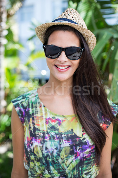 улыбаясь красивой брюнетка соломенной шляпе солнце Сток-фото © wavebreak_media